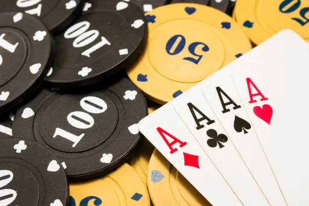 Photo of combination of four aces closeup on poker chips