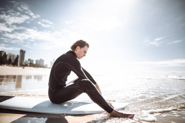 surfer walking in surfers paradise beach in australia