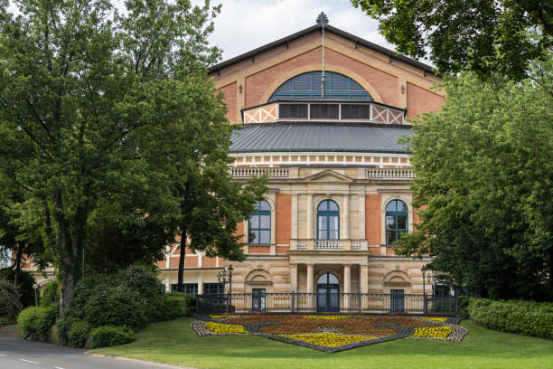 Close up from the famous bayreuth wagner festival theatre from the front with colorful flowers. Close up from the famous bayreuth wagner festival theatre from the front with colorful flowers bayreuth stock pictures, royalty-free photos & images
