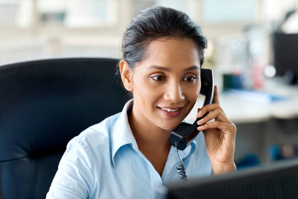 istock Businesswoman using landline phone in office 965601904