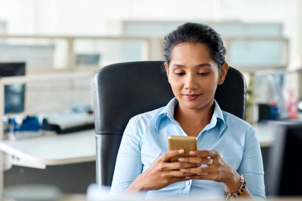 istock Young businesswoman using mobile phone in office 965601922