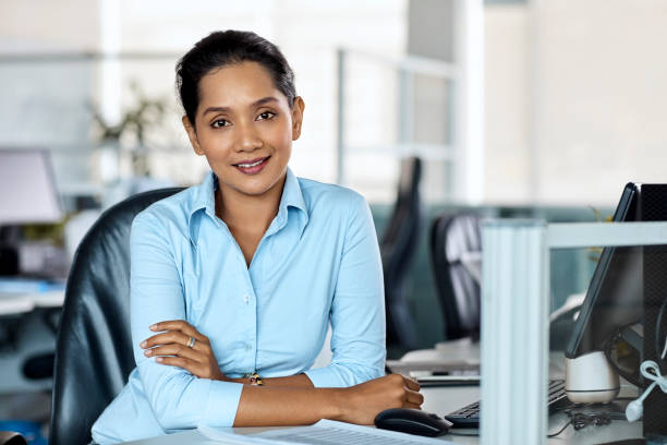 istock Confident young businesswoman sitting at desk 965602068