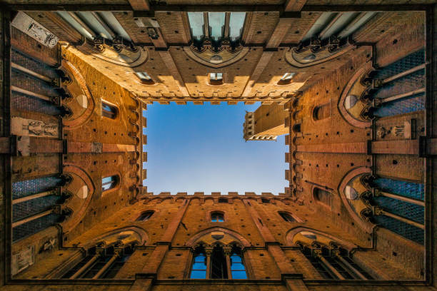 istock A shot from inside palazzo pubblico in Siena with a blue sky as a background looking like a stamp 965602148