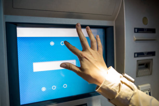 istock young woman inserting a credit card to ATM 965603592