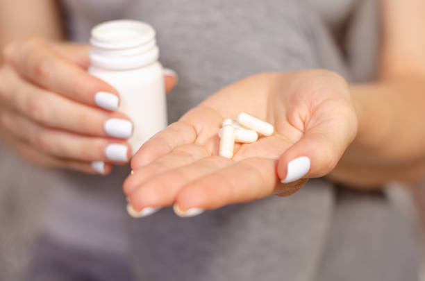 istock Woman sick in hands jar of pills 965603670