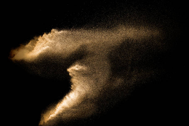 istock Abstract sand cloud. Golden colored sand splash agianst dark background. Yellow sand fly wave in the air. Sand explode on black background ,throwing freeze stop motion. 965606230