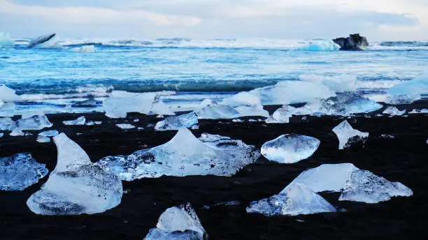 View of iceburgs washed up on the black sands of Diamond Beach