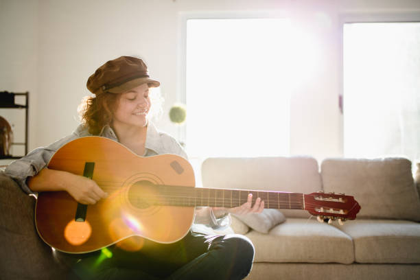 istock Woman playing guitar and enjoying 965645536