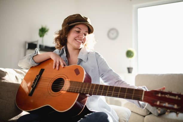 istock Woman playing guitar and enjoying 965647758