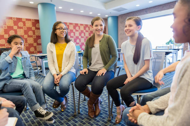 istock Teacher talks with group of female students 965665298