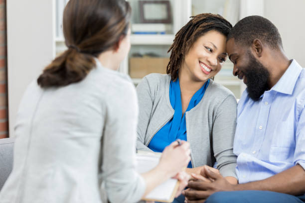 istock Happy couple talk with therapist 965665502