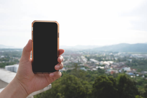 istock Man hand holding and using smartphone with blank desktop screen at outdoor nature. 965666146