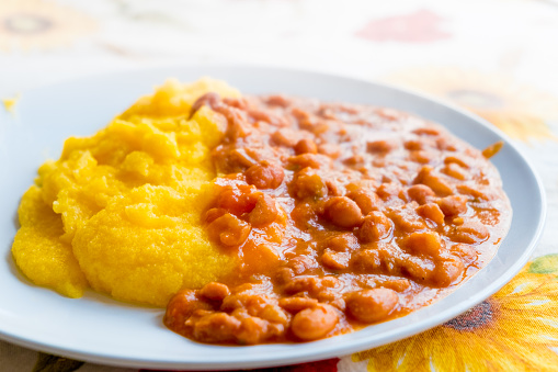 closeup of old traditional polenta and beans italian farmers dish