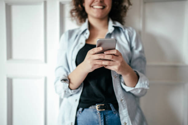 istock Happy young girl using smart phone 965675070