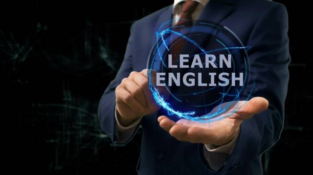 istock Businessman shows concept hologram Learn English on his hand 965677762