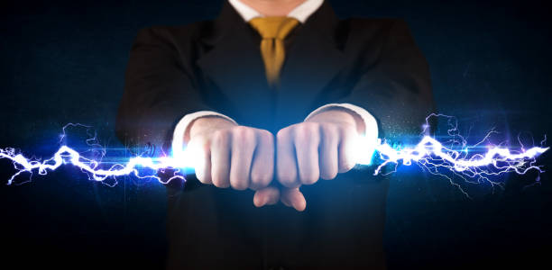 istock Business man holding electricity light bolt in his hands 965678224