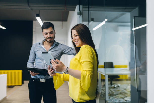 istock Two business people discussing business strategy using digital tablet 965679358