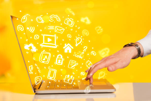 istock Hand writing on notebook computer with media icons and symbols 965681904