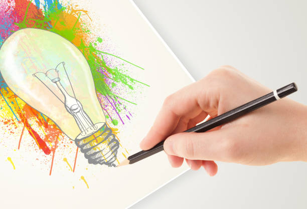 istock Hand drawing on paper a colorful splatter lightbulb 965682036