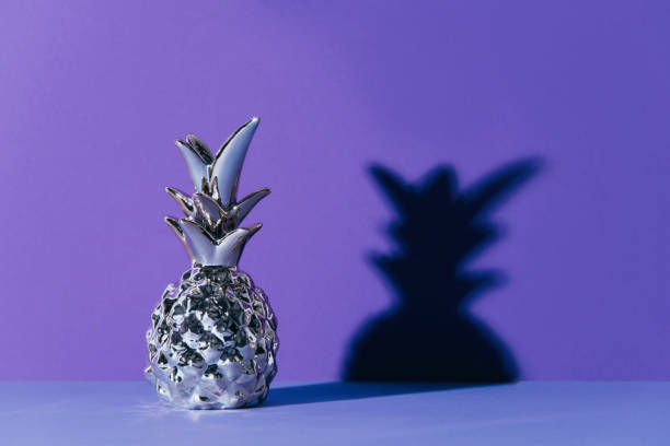 istock Tropical golden Pineapple on ultraviolet background 965686856