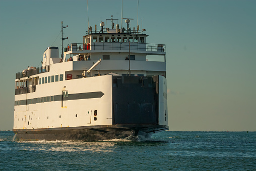 Views of the Island Queen ferry service in Falmouth harbor in Falmouth, MA on Cape Cod.  The ferry makes frequent trips to Martha's Vineyard during the summer months.