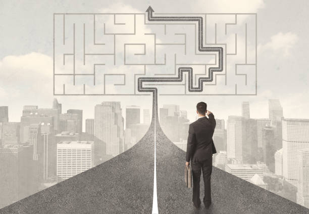 istock Businessman looking at road with maze and solution 965690748
