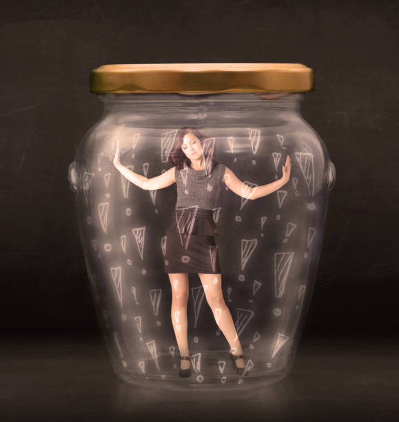 istock Business woman trapped in jar with exclamation marks concept 965690956
