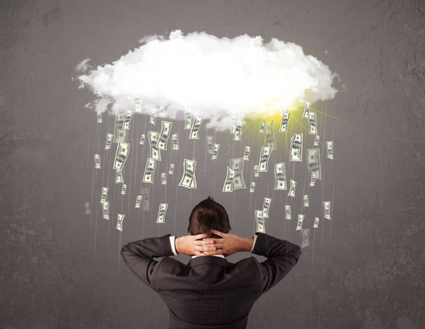istock Business man in suit looking at cloud with falling money 965691174
