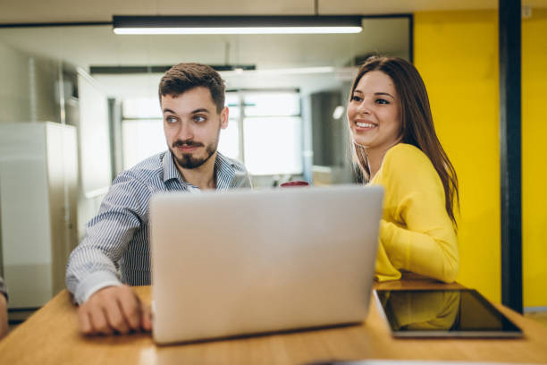 istock Business people using laptop together 965692188