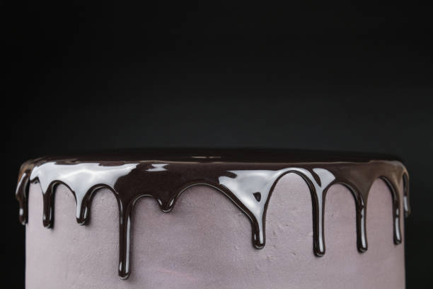 istock Chocolate cake with black glaze on a black background. 965698742