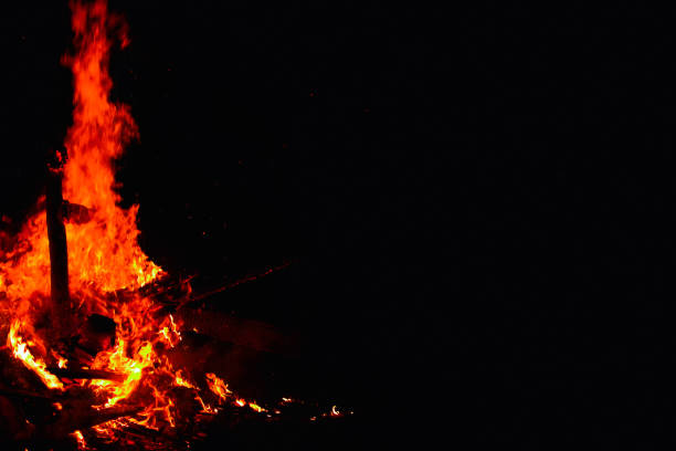 istock Bonfire on a dark background. Beautiful fire flames with copy space on black. Burning wood at night. 965698890