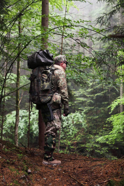 istock Active healthy man hiking in beautiful forest 965701842