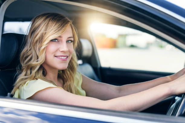istock Attractive young woman driving a car 965710888