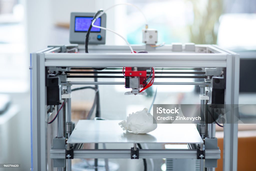 Modern 3D printer creating model of heart Best functions. State-of-the-art 3D printer creating a new model of a heart, recreating all details 3D Printing Stock Photo