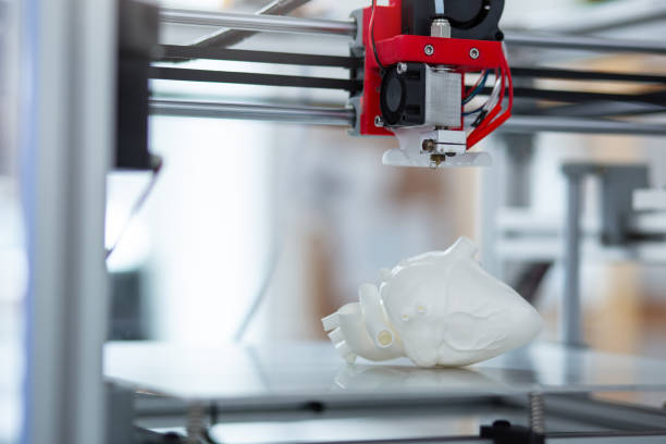 istock Close up of 3D printer creating a model of heart 965714690