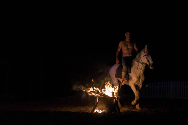 istock Cowboy and Horse Silhouette at a Campfire 965716070