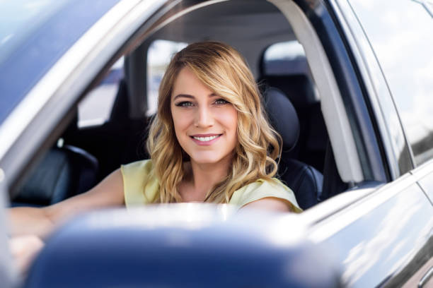 istock Attractive young woman driving a car 965716156