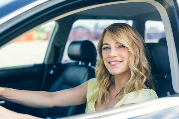 istock Attractive young woman driving a car 965718682