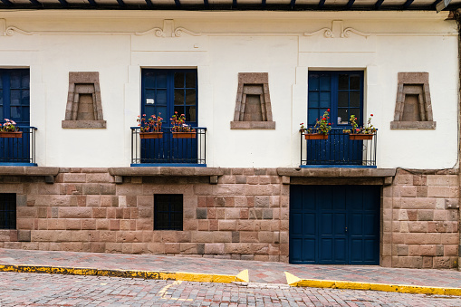 Facade of typical house in San Blas neighborhood in Cusco (Peru) with floral balconies