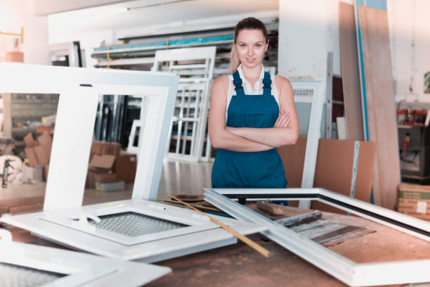 istock Confident girl assembler of plastic windows standing with arms crossed 965723682