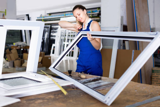 istock Woman using screwdriver on assembling of window frame at factory 965723686