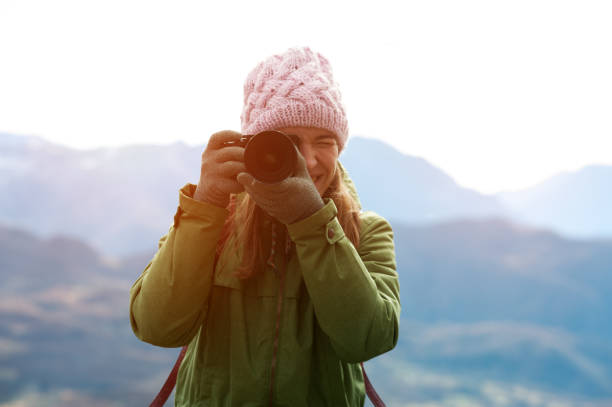 istock Woman in autumn clothes with camera 965724150