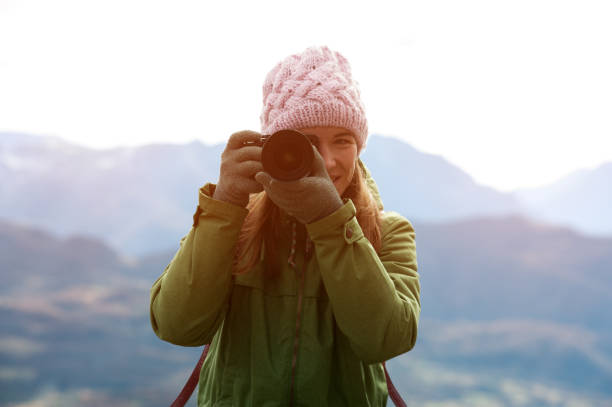 istock Woman in autumn clothes with camera 965724188