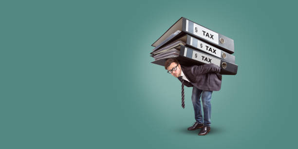istock Man carrying a giant stack of tax folders 965724626