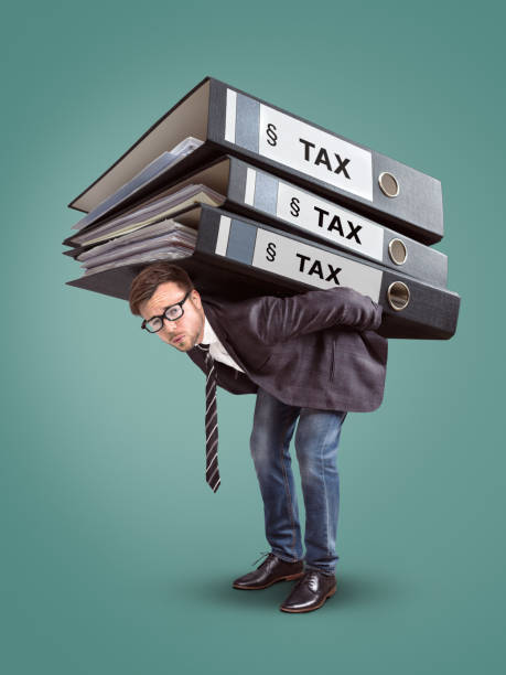 istock Man carrying a giant stack of tax folders 965725172