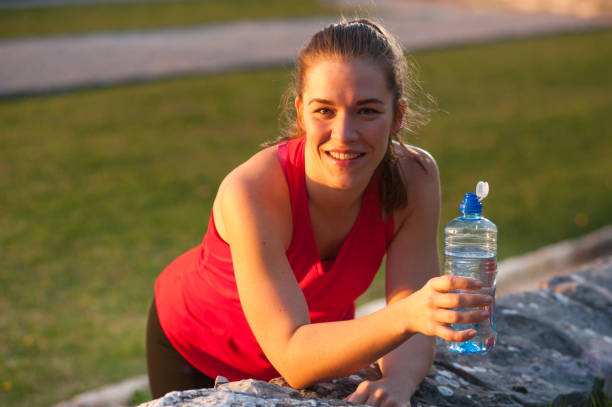 istock Sportswoman Resting with Water During Workout 965725264