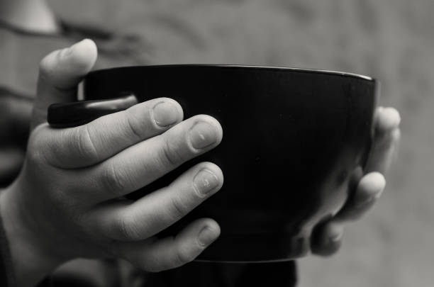 istock The palms of the hungry boy hold an empty plate. 965729248
