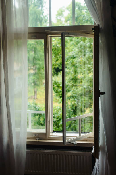 istock Open window view outside at country side village house 965746848