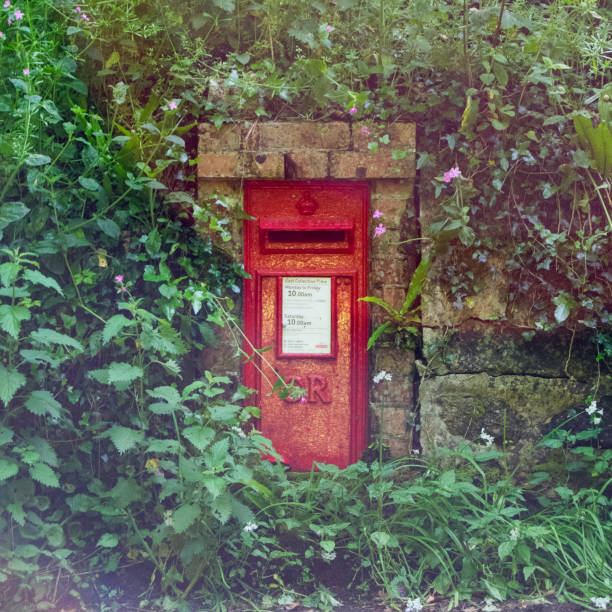 Post Box near Lamorna Cove, Cornwall UK Red Post Box in the wall by the roadside near Lamorna Cove lamorna cove stock pictures, royalty-free photos & images