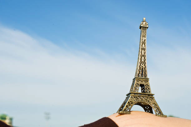 istock Pregnant Woman Hold Up The Eiffel Tower Replica 965761952